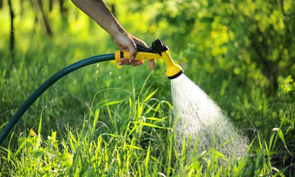 Use A Garden Hose To Rinse Off Large Spillages